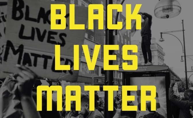 Description: The words Black Lives Matter in large yellow font on a black and white photograph of people at a protest. Image from blacklivesmatter.com.